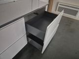 a white cabinet with two drawers in a room