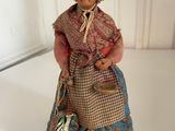 a figurine of a woman with a basket on her lap
