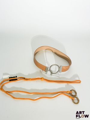 une ceinture munie d'un anneau métallique auquel est attachée une lanière