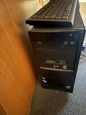 a computer tower with a keyboard on top of it