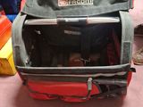 a red suitcase with a laptop in it sitting on the floor