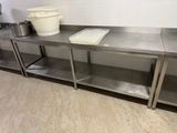 a metal counter with two buckets on top of it