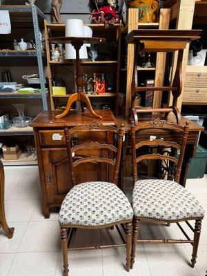 two chairs and a table with a mirror on it
