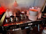 a coffee machine that has many cups on top of it