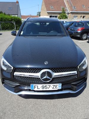 the mercedes gle is parked in a parking lot with other cars in the background