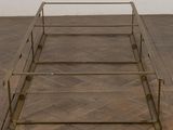 a metal bed frame on a wooden floor in a room