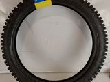 a tire that is sitting on a white surface