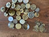 many different types of buttons on a wooden table
