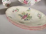 a lot of plates and bowls that are on a table