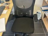 a desk with a computer and a chair in front of it