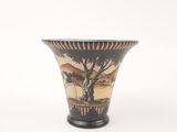 a vase with a painting on it sitting on a table