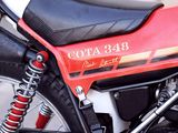 a red and black motorcycle parked on the side of the street