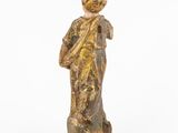 an old wooden statue of a man with a hat on his head