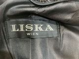 a close up of a black jacket with a fur collar