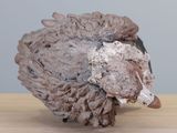 a sculpture of a sheep that is sitting on a table