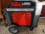 an image of a small portable generator on wheels