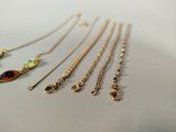 many different types of necklaces on the table
