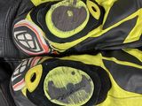 pair of yellow and black motorcycle gloves sitting on top of a table