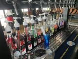many bottles of alcohol lined up on the bar