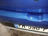 a close up of a blue car with a license plate on it