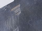 a close up of a metal object on a white surface