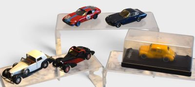 four different models of cars on display in a display case