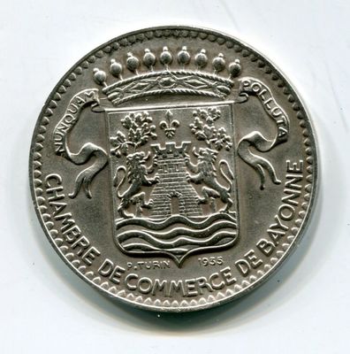 an image of a silver coin with a coat of arms and a crown on it