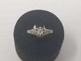 a close up of a ring in a black box on a white surface