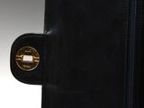 a close up of a black purse with a gold lock on it