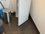 an image of a small kitchen with a small refrigerator