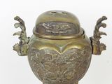 bronze incense burner on stand with ornate decoration on white background