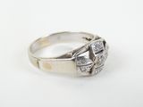 a close up of a diamond ring on a white surface