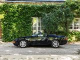 a black sports car parked in front of a house