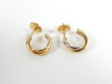 a pair of gold and silver hoop earrings on a white background