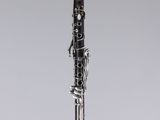a black and silver clarinet on a white background