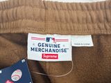 L'étiquette sur le pantalon indique « Genuine Merchandise Supreme ».