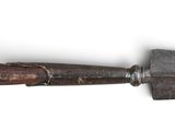 an old rusty tool with a wooden handle on a white surface