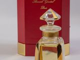 an image of a bottle of perfume sitting next to a box