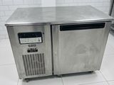 stainless steel counter top freezer in a commercial kitchen with tile flooring