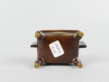 an image of a small wooden box with a tag on it