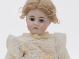 a small doll that is sitting on a white surface