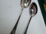 two spoons sitting next to each other on a table