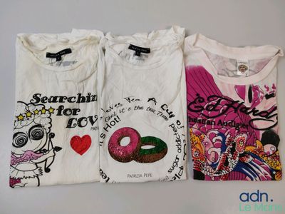 three t - shirts with different designs on them sitting on a table