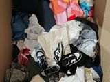 a cardboard box filled with clothes and other items