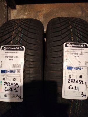 two tires are sitting side by side on the ground
