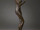 an image of a bronze statue of a woman holding a flower