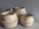 three woven baskets with handles and handles on a grey background