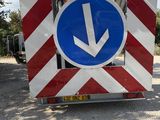 a red and white striped truck with a blue arrow on it