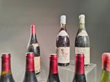 several bottles of wine are lined up in a row on a table