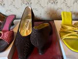 three pairs of women ' s shoes sitting on top of a box